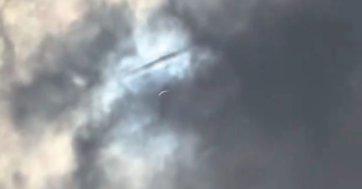 A UFO appeared above the clouds during the eclipse